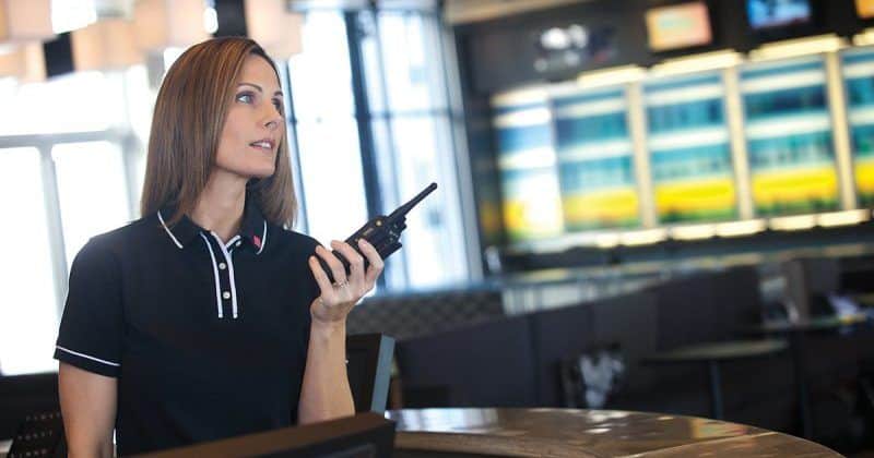 Woman communicating with a walkie-talkie