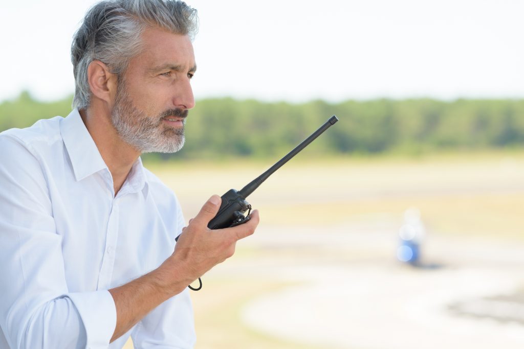 Bearded man using a walkie talkie