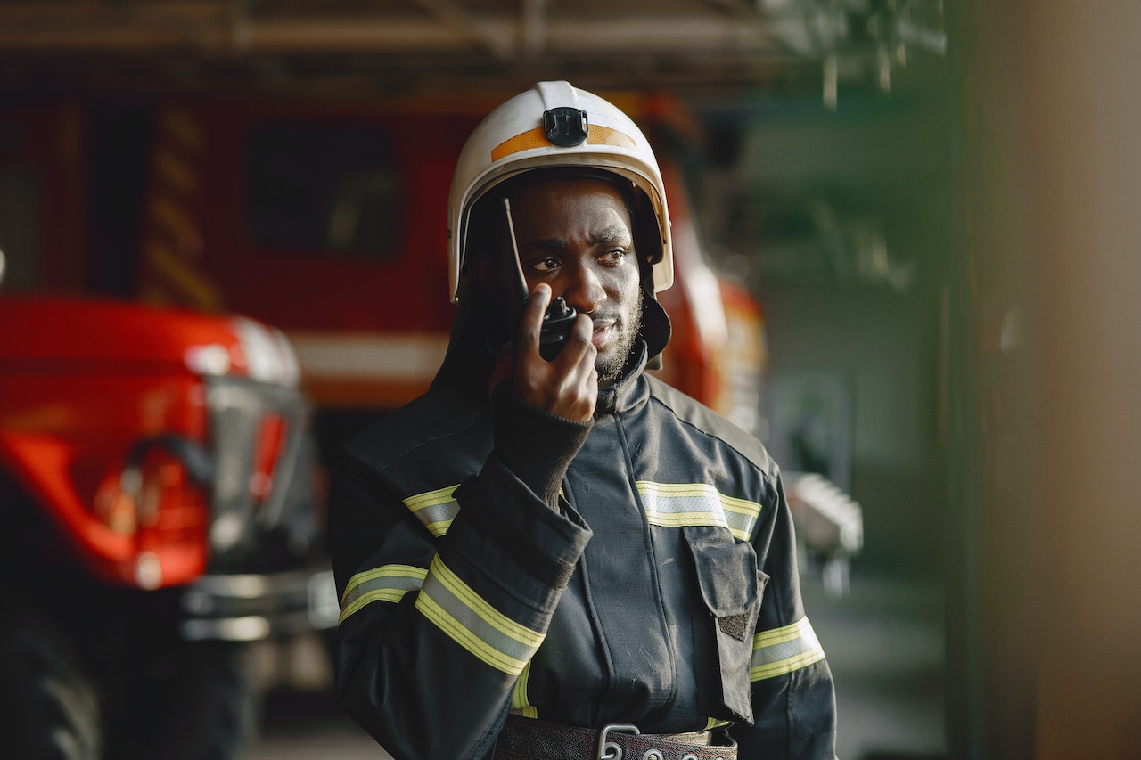A firefighter using a walkie-talkie for communication